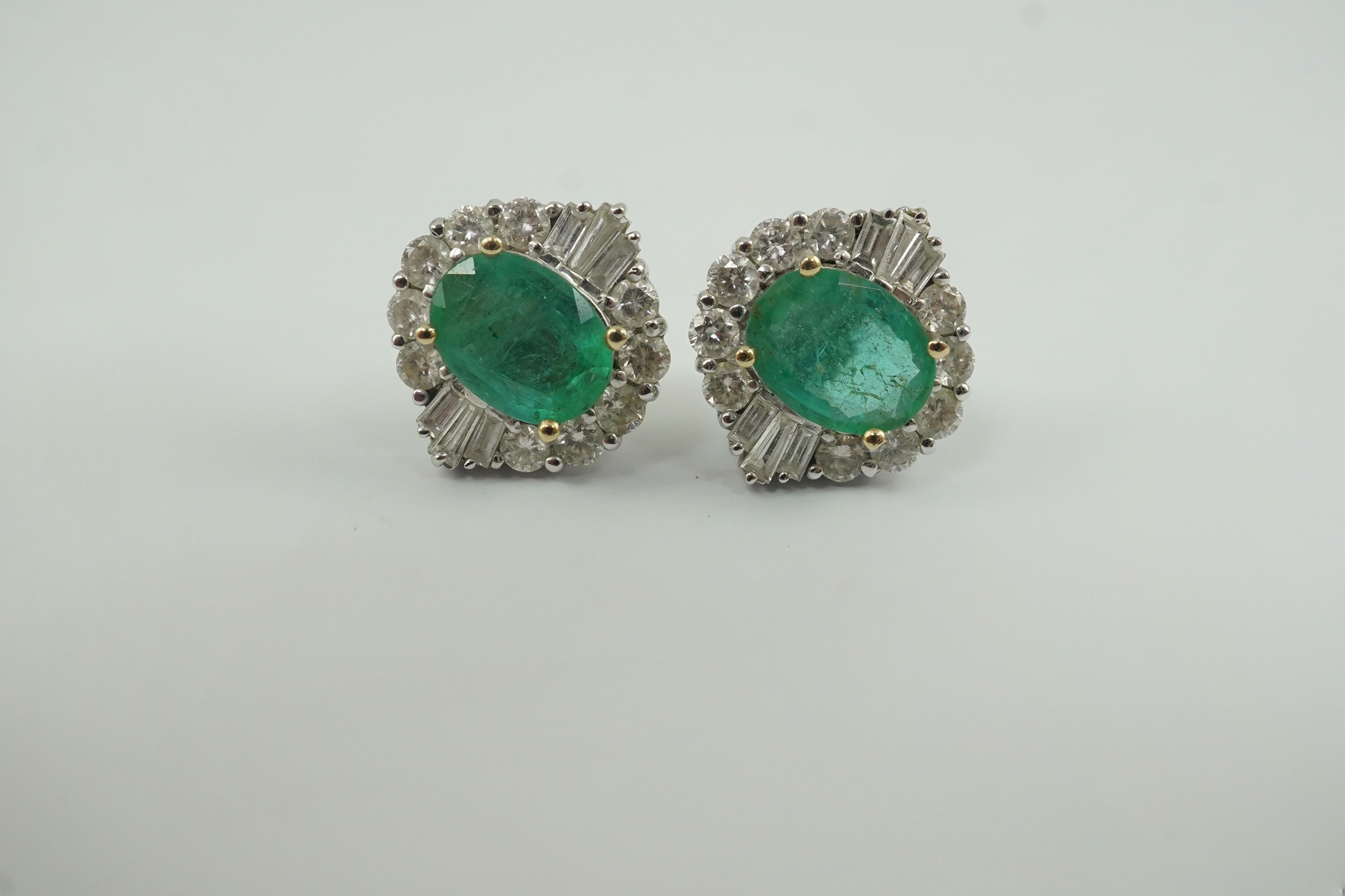 A pair of Art Deco style white gold, emerald and diamond cluster earrings